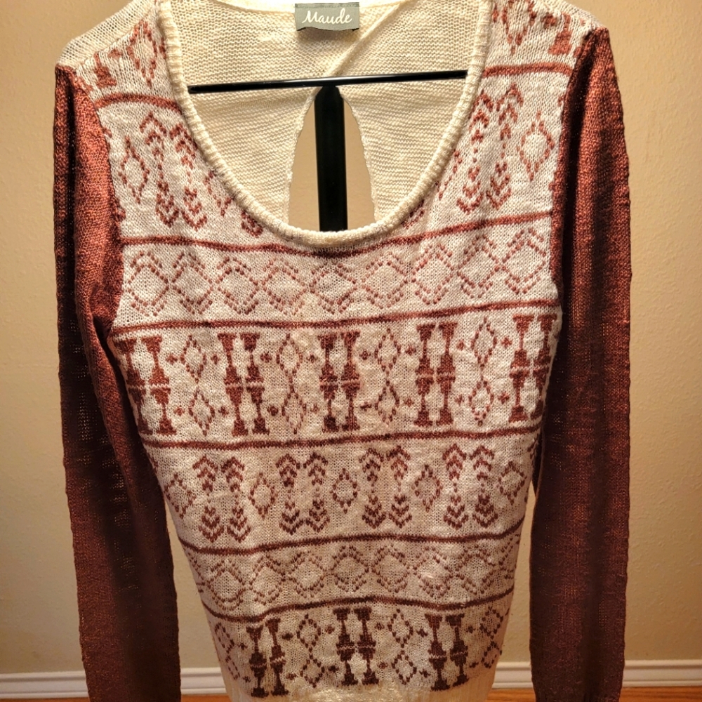 Unique light sweater with open back.